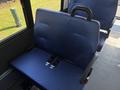 2020 Chevrolet Express interior seat with blue fabric and seatbelt visible
