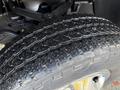 Close-up of a tire from a 2013 Chevrolet Silverado 3500HD showcasing the tread pattern and rubber surface