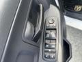 Close-up of the driver's side door control panel in a 2012 RAM 2500 featuring window and lock controls