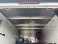A 2016 RAM 1500 truck with an open and empty bed showcasing metal framing and equipment like a motor and hose reel inside the truck's cargo area
