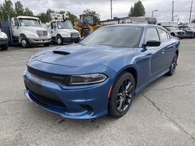 A blue 2022 Dodge Charger with a sleek design featuring a prominent front grille and hood scoop, and blacked-out wheels