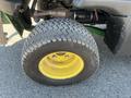 A close-up view of a yellow and black tire from a 2016 John Deere 1585 Terrain Cut showing its tread pattern and wheel rim
