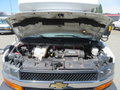 2020 Chevrolet Express with its hood open revealing the engine compartment and various engine components