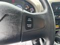 Close-up of the steering wheel of a 2013 International DuraStar 4300 featuring cruise control buttons for setting and resuming speed