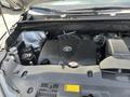Engine compartment of a 2018 Toyota Highlander showing the Toyota logo on the engine cover and various engine components