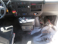 Interior view of a 2020 Chevrolet Express showing the driver's seat dashboard and central console with various controls and wires visible