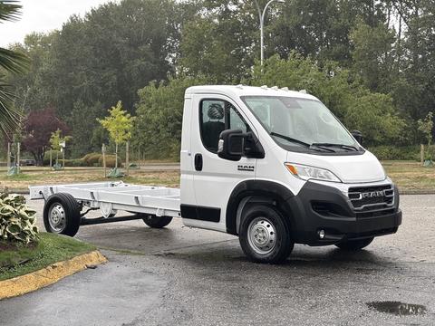 A 2023 RAM Promaster 3500 chassis cab with a white exterior and a flatbed designed for customization and utility use