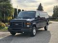 A blue 2013 Ford E-350 Super Duty van with a black grille and high ground clearance parked on a paved surface