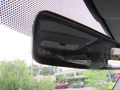 Rearview mirror of a 2009 Dodge Sprinter Van with a black frame and a reflective surface showing the interior view