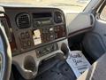 Interior dashboard of a 2012 Freightliner M2 106 featuring controls gauges and a radio with a thank you mat on the floor