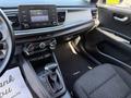 Interior of a 2018 Kia Rio5 featuring a dashboard with a touchscreen display climate controls and an automatic gear shifter on the center console