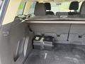 Interior view of the cargo area of a 2015 Ford Escape showing storage space and a secured battery compartment at the back