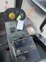 Control panel of a 2013 Toro Grounds Master 5910 featuring various switches buttons and a key with a tag attached