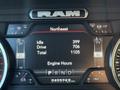 The image shows the dashboard display of a 2023 RAM 3500 with readings for idle, drive, total kilometers, and engine hours