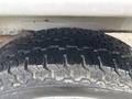 Close-up of a tire from a 2008 Suzuki Carry showing tread pattern and wear on the rubber surface