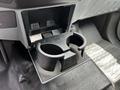 A cup holder in a 2016 Ford F-550 pickup truck interior designed to hold two cups securely