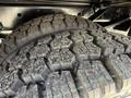 Close-up of the large, rugged tires of a 2024 Ford F-550 showcasing deep treads designed for off-road performance and durability
