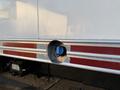 Close-up of a circular access port on a 2015 GMC Savana with blue interior and metal surrounding featuring red reflective tape on silver trim