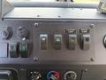 Dashboard control panel of a 2017 Freightliner MT45 featuring various switches and indicators for functions like courtesy lamps and a backup alarm