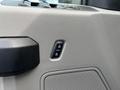 A close-up of the interior door panel of a 2017 Ford F-250 SD featuring window and door lock control buttons