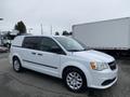 White 2014 RAM Cargo Van with sliding side doors and alloy wheels parked at an angle