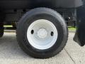 A black Michelin tire mounted on a white rim with five bolt holes designed for a 2008 International 4300 vehicle