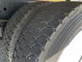 Close-up of the tread on a truck tire from a 2013 Mitsubishi Fuso FE160 showing deep grooves and wear patterns