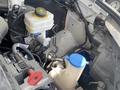 A close-up view of the engine compartment of a 2024 Mercedes-Benz Sprinter showcasing various components including a reservoir and hoses