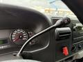 Dashboard of a 2007 Ford F-550 showing the speedometer gauges and a tow hall switch on the steering column