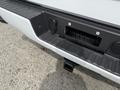 Close-up of the rear bumper of a 2018 Chevrolet Silverado 1500 showing the hitch receiver and wiring harness connector