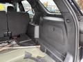 Interior of a 2019 Ford Explorer showing a black fabric seatback and a storage compartment beside it