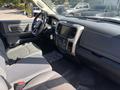 Interior of a 2014 RAM 5500 showing the dashboard steering wheel and seats in gray fabric with a large infotainment screen and various controls