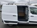 A 2017 Ford Transit Connect van showing an open sliding side door with interior shelving and a wooden partition visible inside