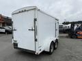 A white 2016 Continental cargo trailer with a double rear door and two wheels at the bottom