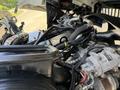 A close-up view of the engine components of a 2009 International 3000 CE including hoses wires and machinery parts