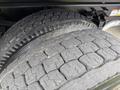 Close-up of two heavy-duty tires from a 2017 Ford F-750 showcasing worn tread patterns and robust construction