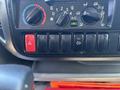Dashboard controls of a 2018 Hino 195 featuring knobs for temperature and fan speed several buttons and an air conditioning indicator light