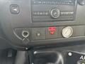 Dashboard controls of a 2018 Chevrolet Express including audio system knobs buttons and gauges