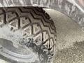 Close-up of a rugged tire from a 2010 Kubota RTV 900 showcasing its deep tread pattern and worn surface