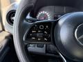 Close-up view of the steering wheel controls of a 2020 Mercedes-Benz Sprinter featuring buttons for cruise control and steering functions