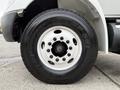 Close-up of a tire and wheel assembly from a 2006 International 4200 featuring a white steel wheel with multiple lug nuts and a black tire with the brand name visible