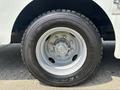 Close-up of a black tire mounted on a silver wheel of a 2011 Workhorse W62 with visible tread details and wheel bolts