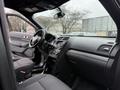 Interior of a 2019 Ford Explorer featuring a steering wheel dashboard and controls with black upholstery and a spacious cabin design