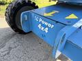 A blue Genie Z 45/25 lift with a tire and metal base featuring yellow directional arrows and white text that reads IC Power 4x4