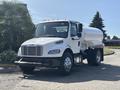 White 2014 Freightliner M2 106 truck with a large cylindrical tank attached to the rear and chrome wheels