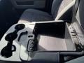 Interior view of a 2014 RAM 5500 truck featuring an open center console with cup holders and a storage compartment