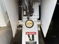 A close-up view of the outrigger control on a 2012 International DuraStar 4300 showing the labels for up and down positions