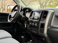 Interior dashboard of a 2013 RAM 3500 featuring steering wheel controls and a touchscreen display with various dials and buttons