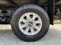 Close-up of a wheel from a 2020 Ford F-350 SD featuring a silver alloy rim and an all-terrain tire with deep treads