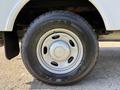 Close-up of a tire mounted on a 2012 Ford F-350 SD featuring a silver wheel and rugged tread pattern